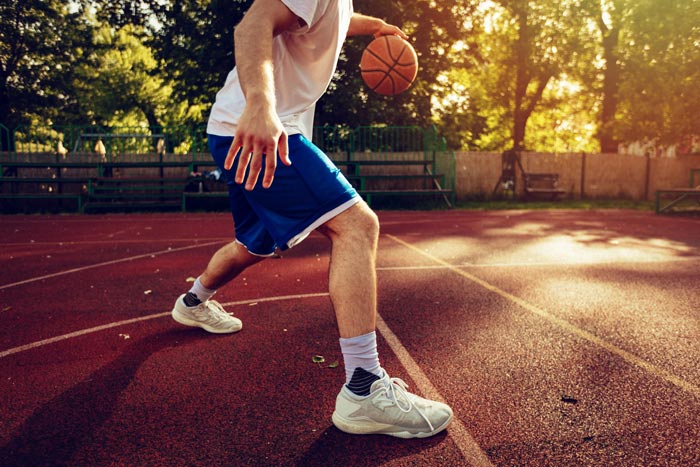man playing basketball outside - recreational therapy