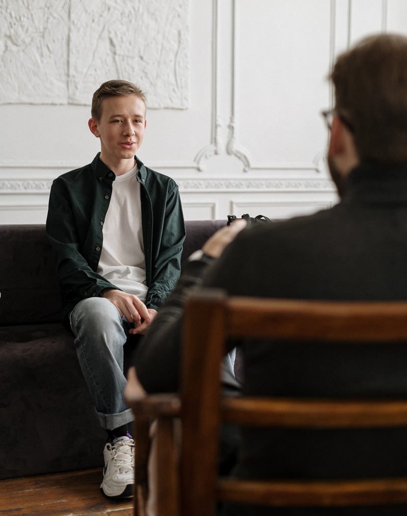 adolescent boy talking to a therapist