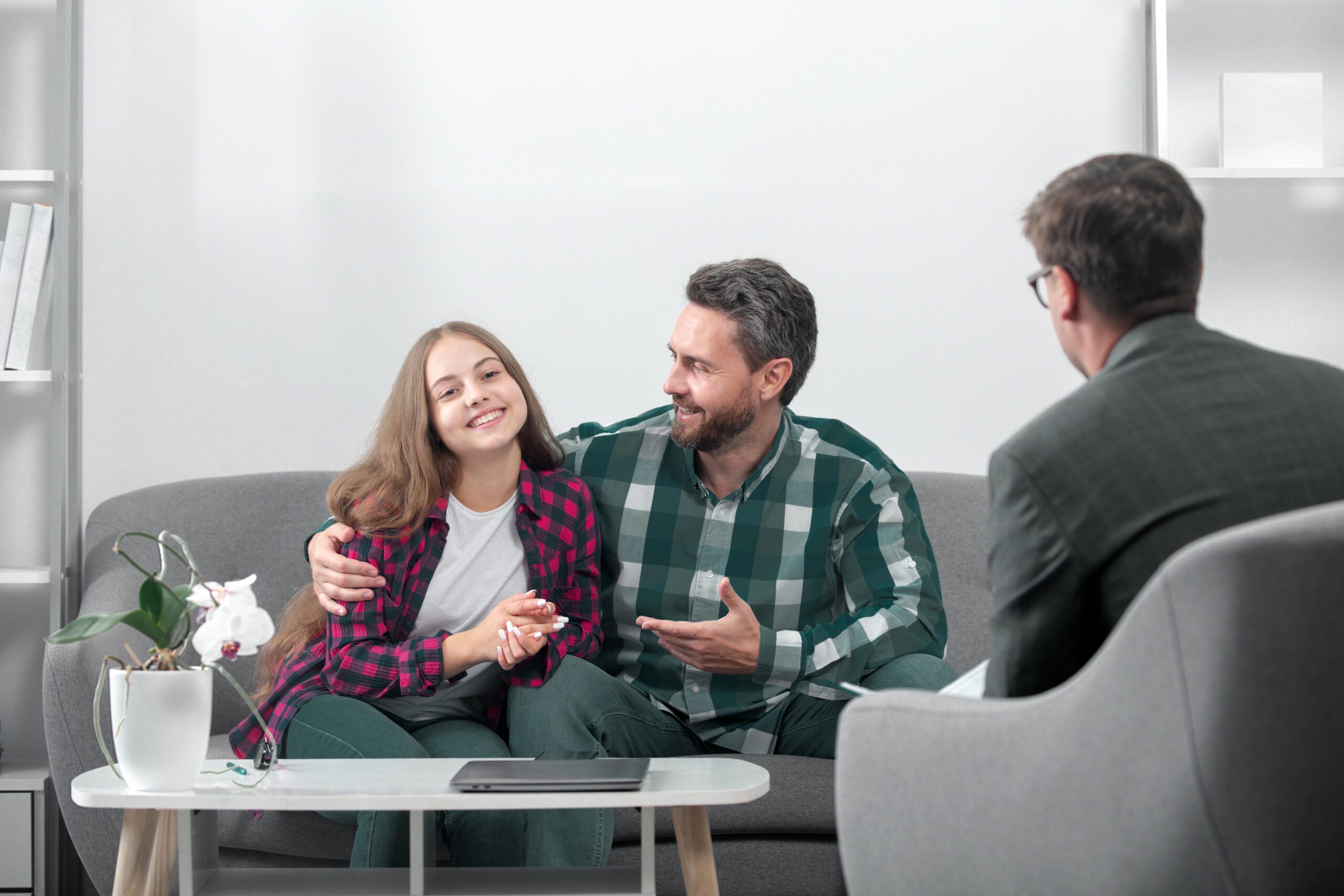 Psychologist helping father with daughter to solve child problems. Parents telling the psychologist about child problems