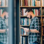 Man browsing books at a library.