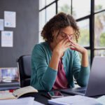 Woman stressed out at her desk at work