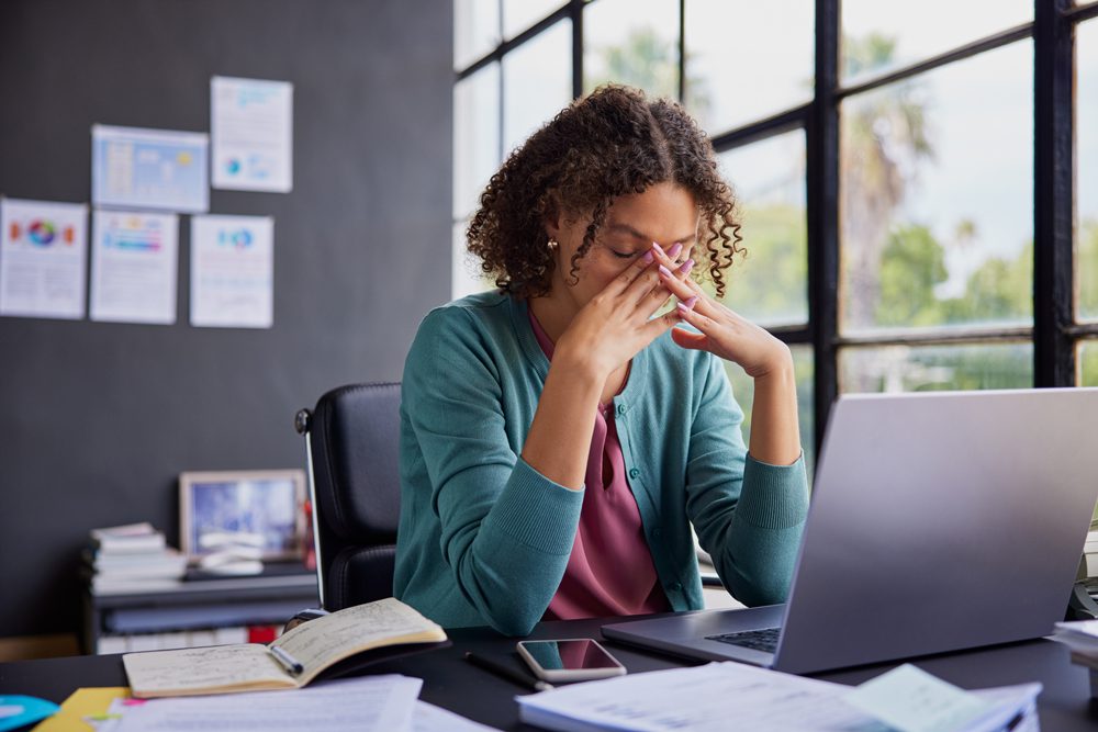 Woman stressed out at her desk at work