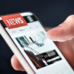 close up photo of news reel on a mobile phone