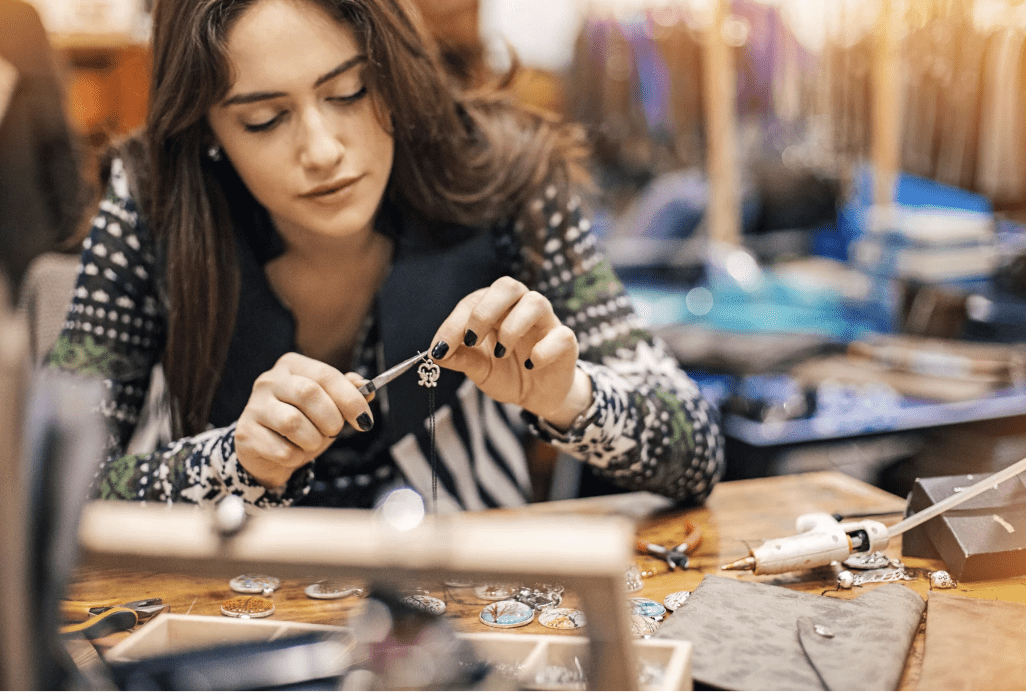 A woman making jewelry.